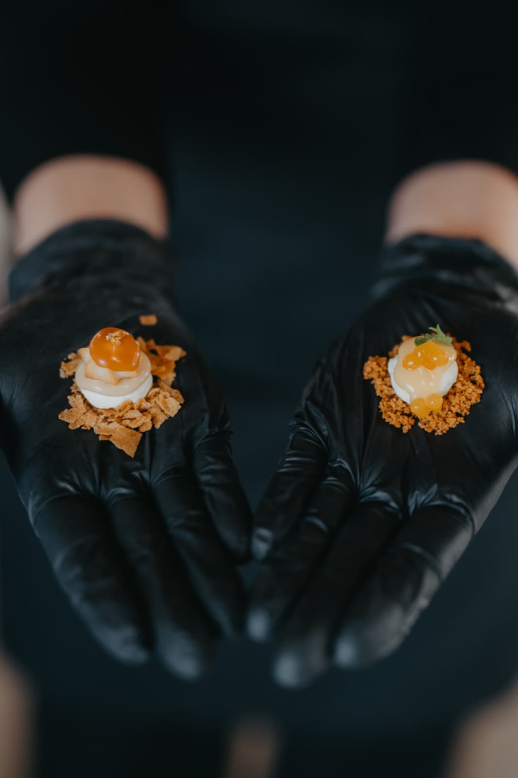 Amuse-bouche served on gloved palms